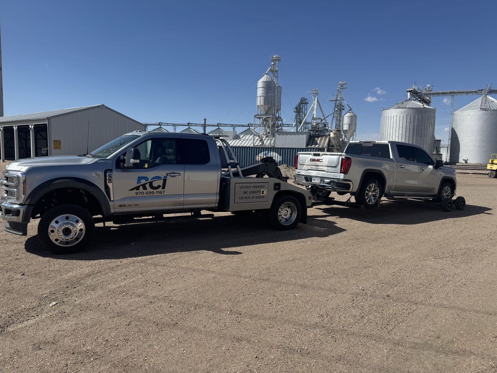 RCI wrecker transporting a pickup in rural Colorado